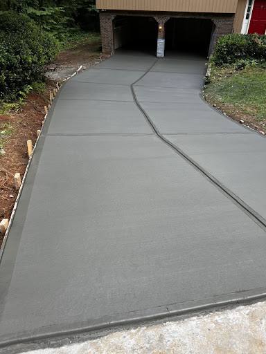 Freshly poured concrete driveway extension.